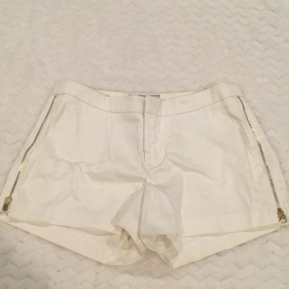 Guess white shorts with gold side zippers